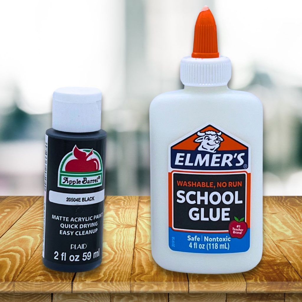 Elmers school glue and black apple barrel acrylic paint on a wood table