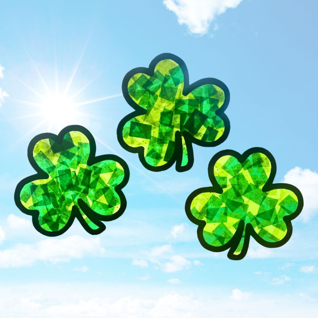 three shamrock sun catchers in the sun tissue paper