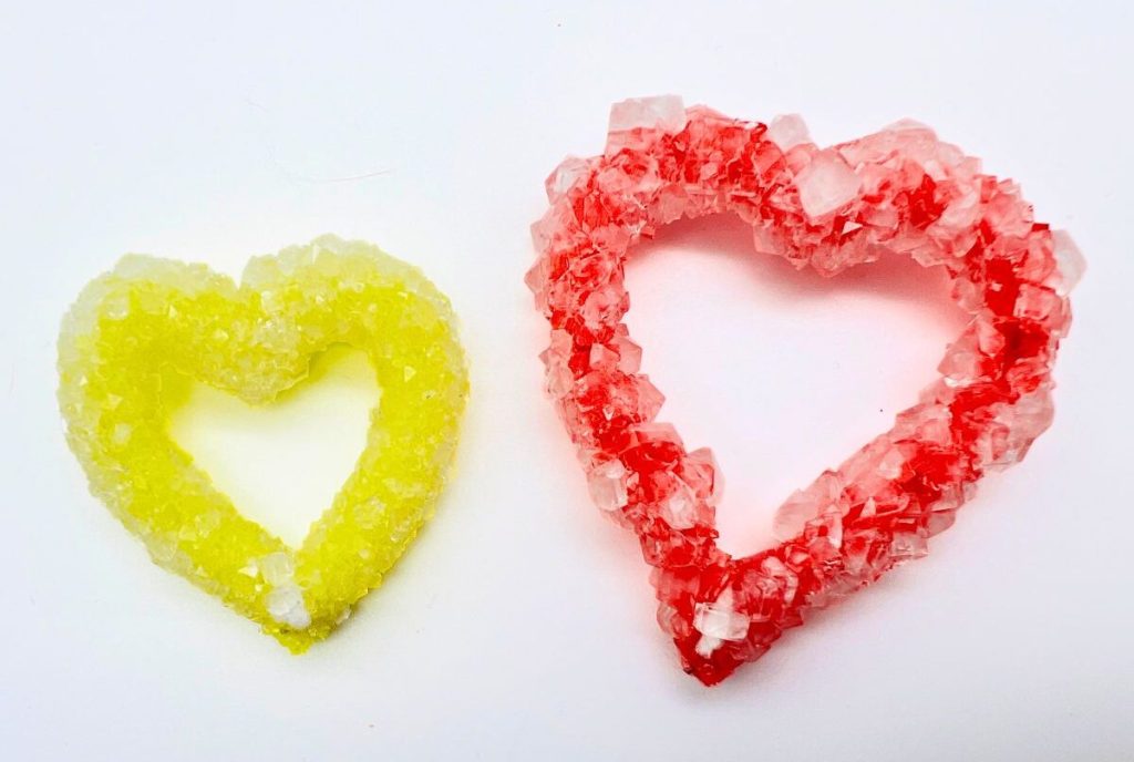 Red and yellow pipe cleaner hearts in borax crystals