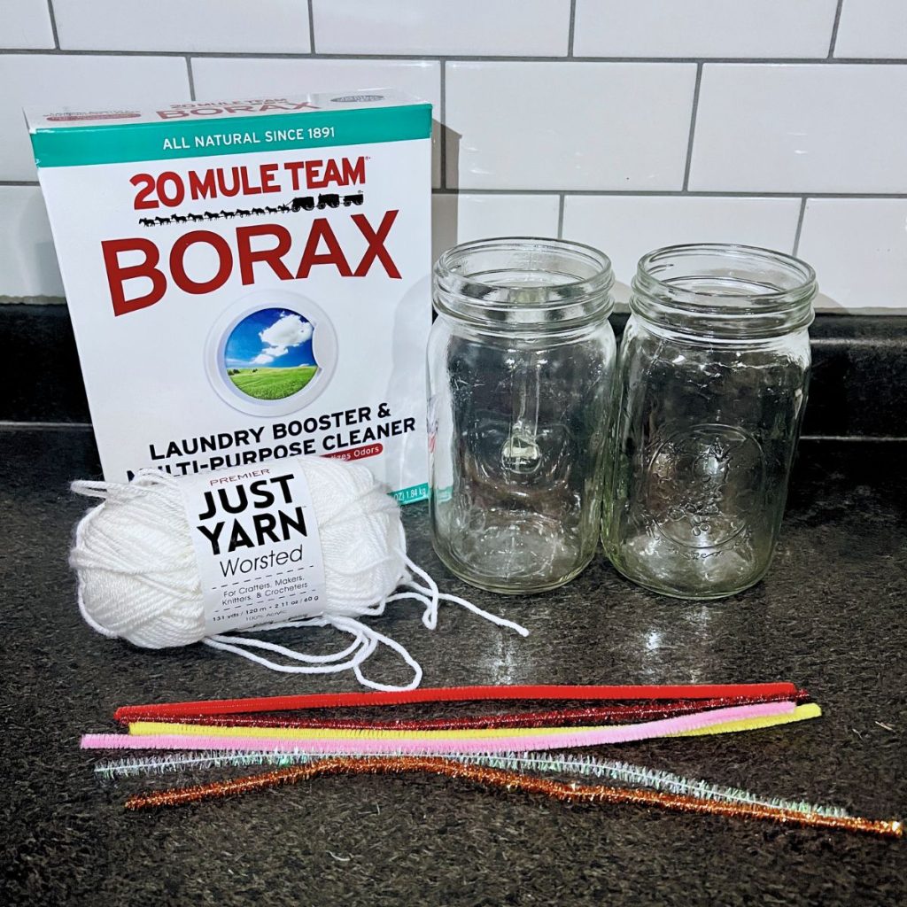 Supplies for Borax crystal hearts with Borax laundry detergent white yarn mason jars and pipe cleaners for Valentine decor