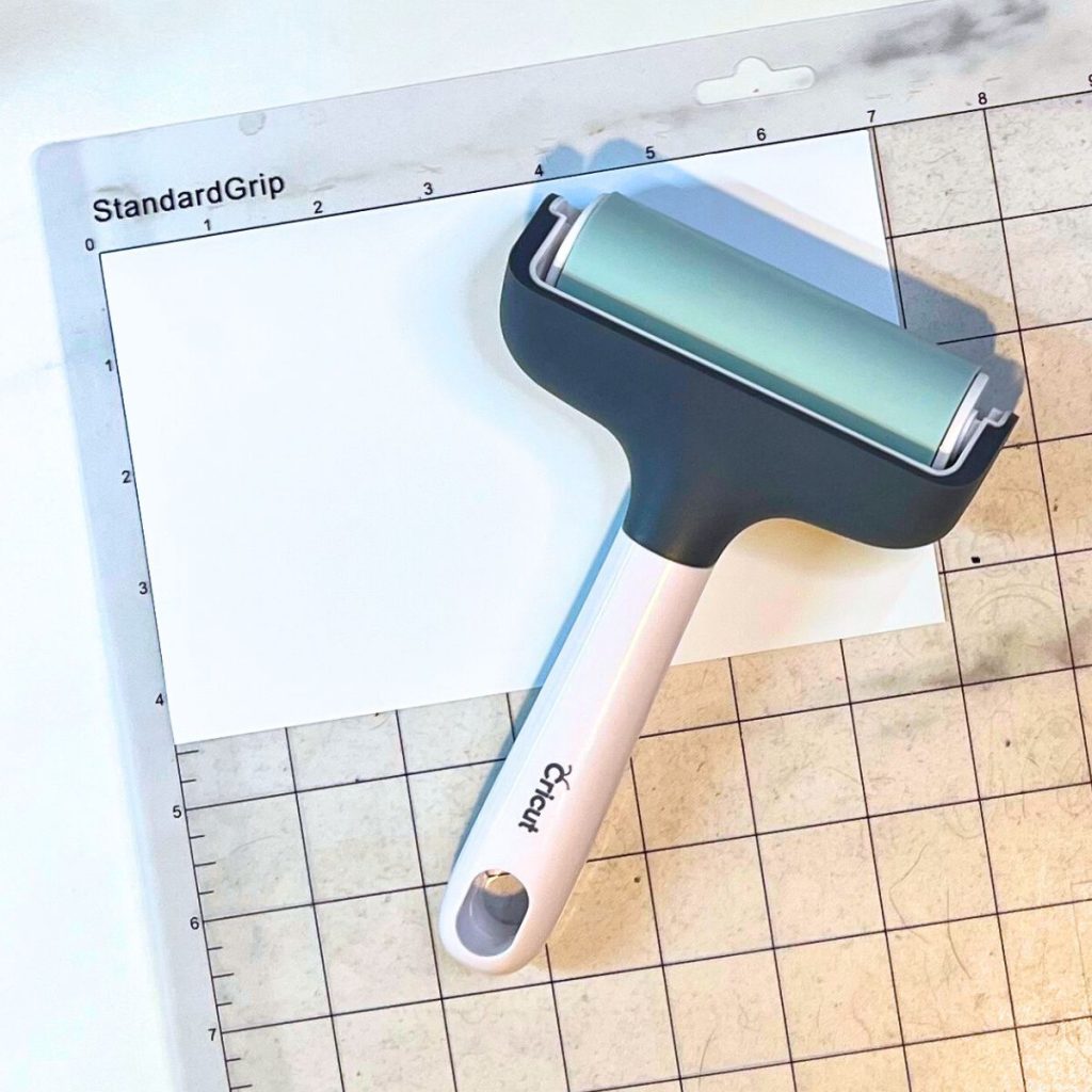 Cricut brayer with white vinyl and clear standard mat