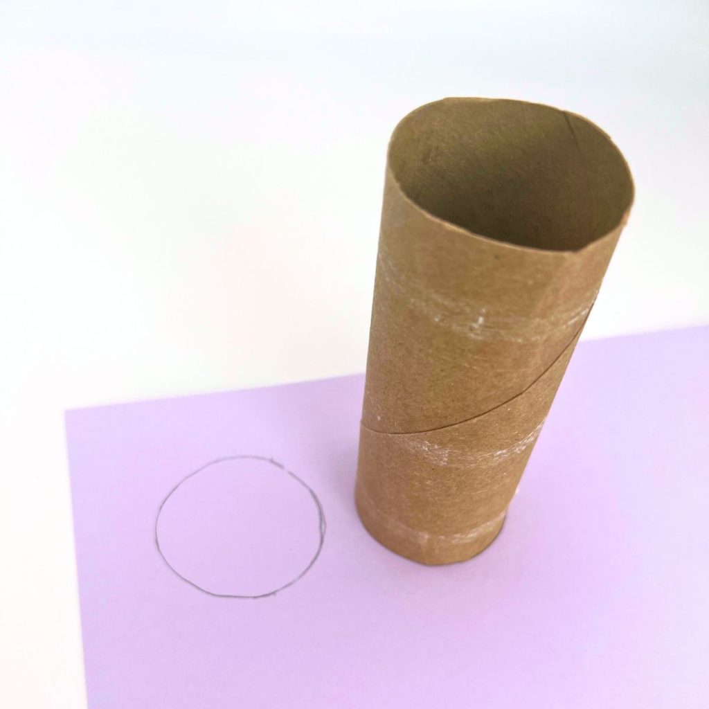 toilet paper roll on purple card stock circle outlined in pencil to make toilet paper roll Easter baskets  