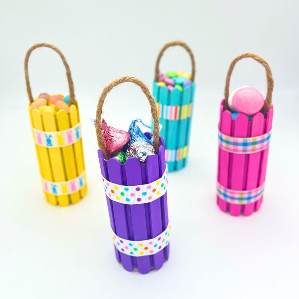 toilet paper roll easter baskets yellow purple blue and pink with popsicle sticks and candy