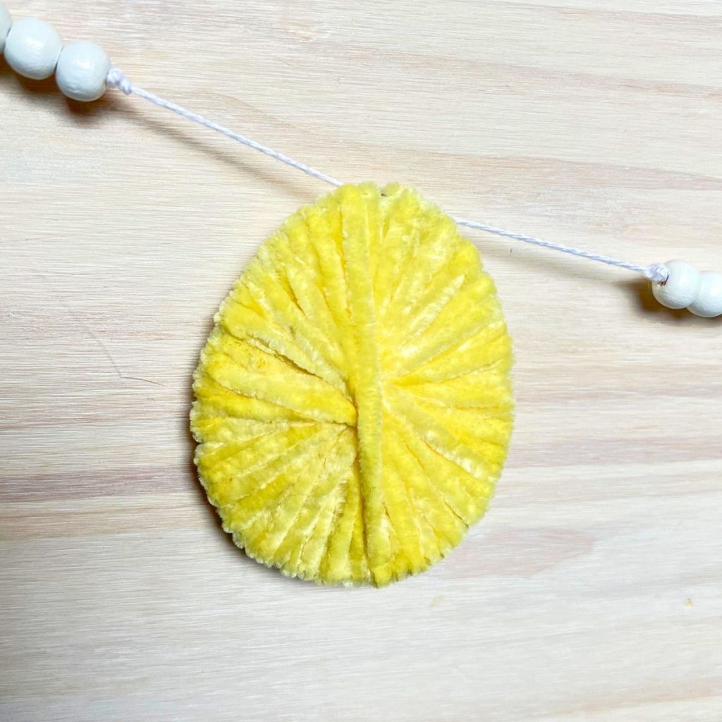 easter egg garland yellow yarn and white beads