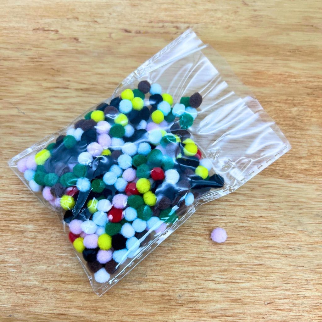 mini colorful pom poms in bag